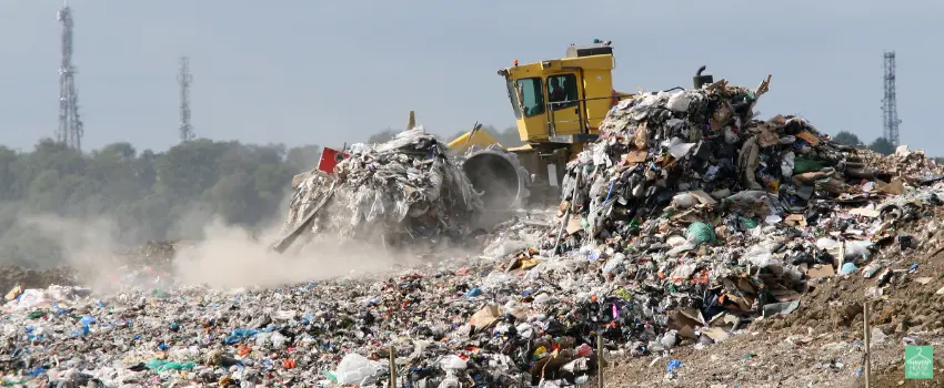 HHTS-A yellow bulldozer processing tons of garbage on a landfill site