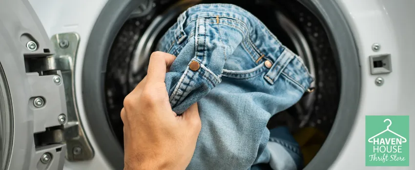 HHTS - Person Putting a Pair of Jeans into the Washing Machine