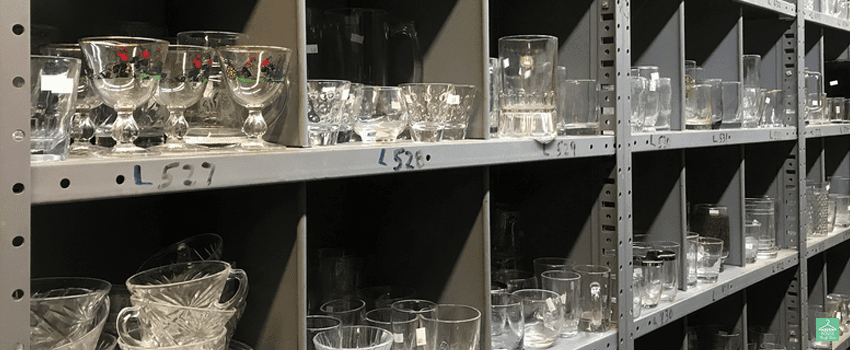 HHTS-Shelves of used clear glassware dishes in thrift shop