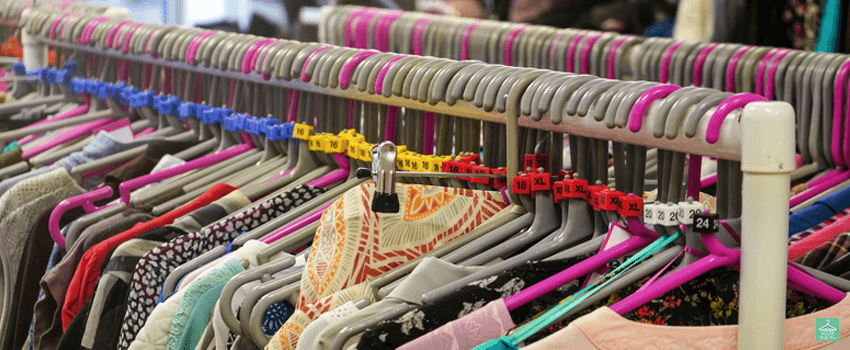 HHTS-Various sizes of ladies clothes displayed on hangers in charity thrift shop